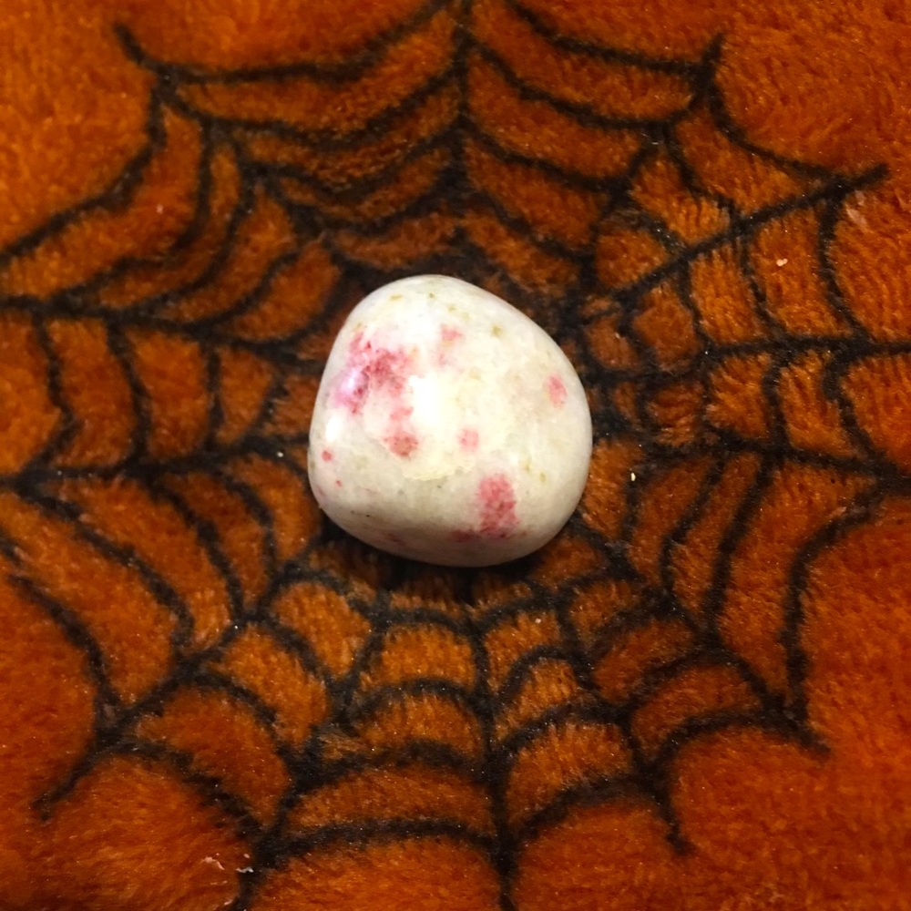 NEW Cinnabar stone (polished), small in size, white with pink spotting in color.